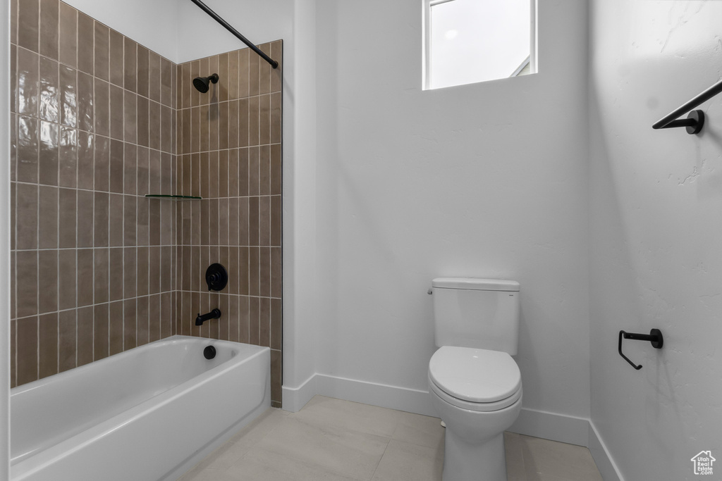 Full bath featuring baseboards and bathing tub / shower combination