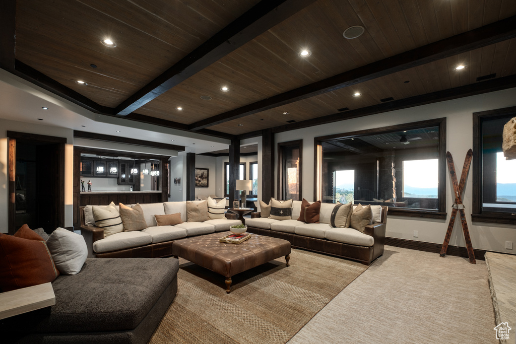 Living area featuring a wood ceiling with exposed beams, recessed lighting, and carpet