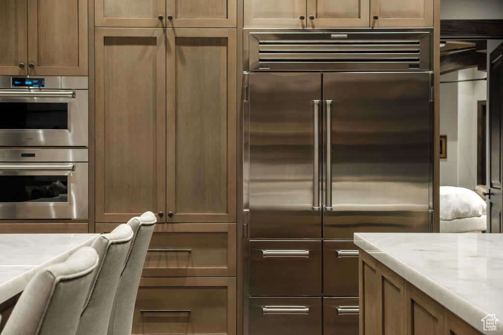 Kitchen with stainless steel appliances and light countertops