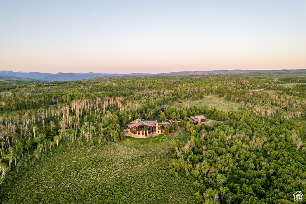 View of subject property with a heavily wooded area