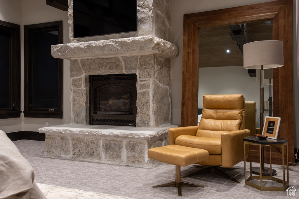 Carpeted living area with a fireplace