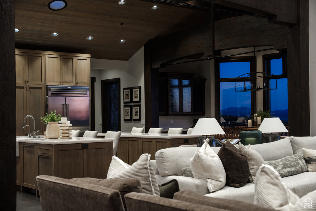 Living room with a chandelier, recessed lighting, and wood ceiling
