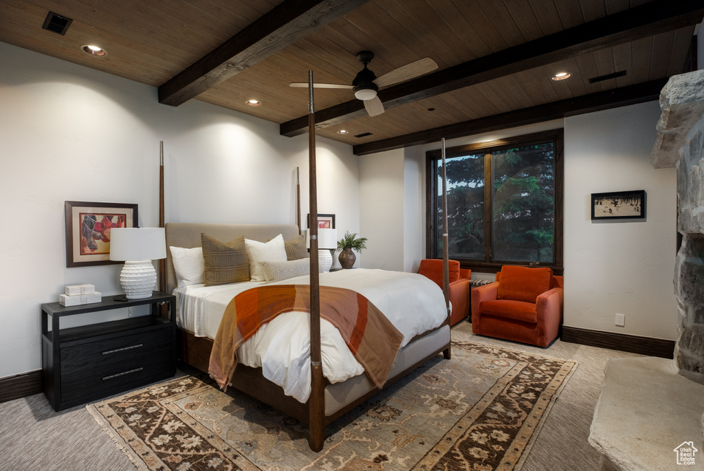 Carpeted bedroom featuring a wooden ceiling with exposed beams, ceiling fan, and recessed lighting