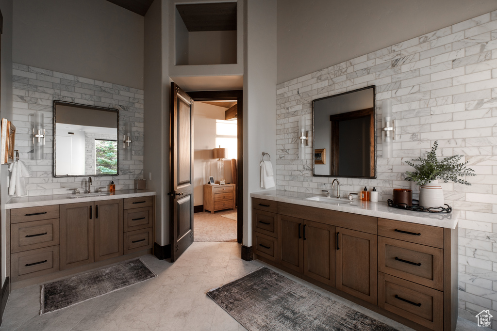 Full bath with backsplash and two vanities
