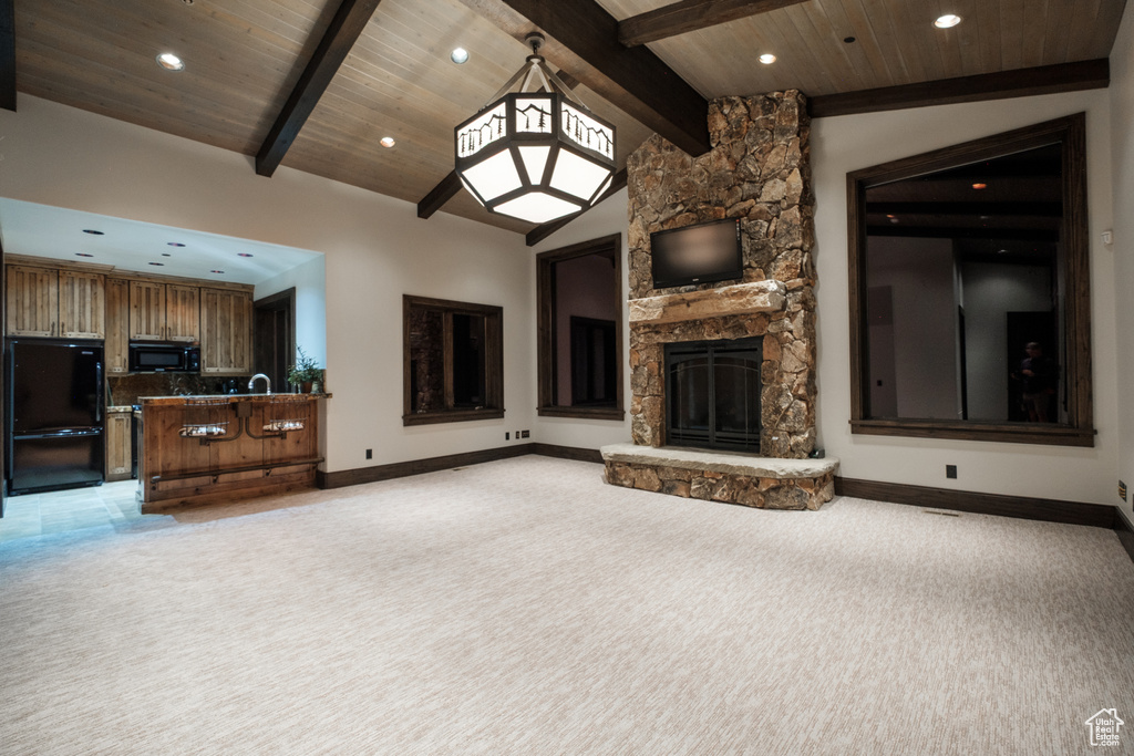 Unfurnished living room with a fireplace, light colored carpet, recessed lighting, and wooden ceiling