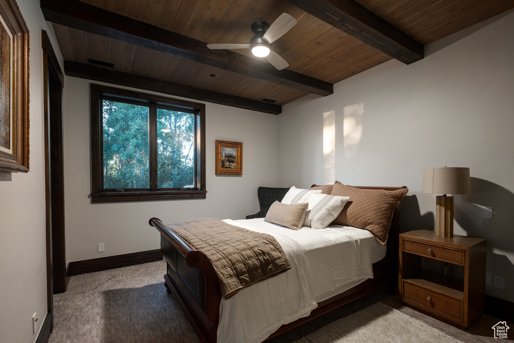 Bedroom featuring a wooden ceiling with exposed beams, carpet, and a ceiling fan