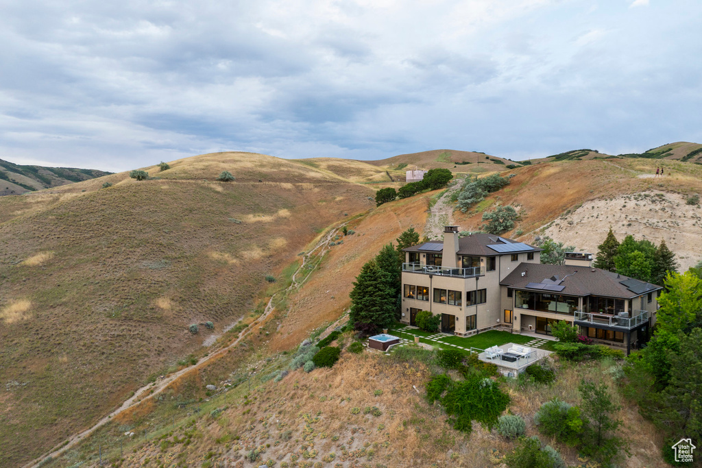 Aerial view of property and surrounding area with a mountainous background