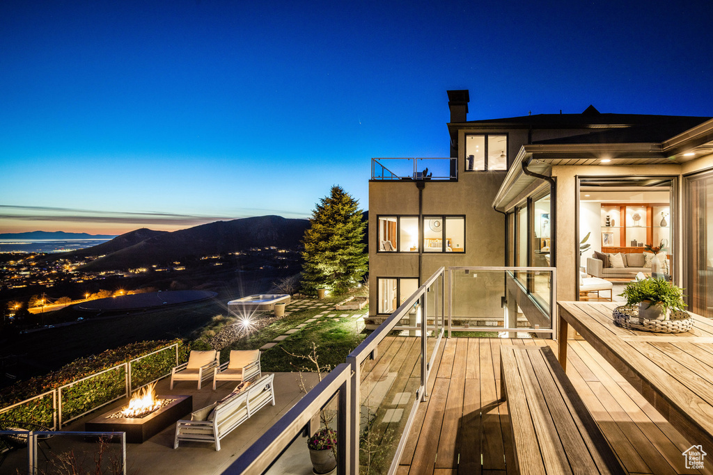 Wooden deck with an outdoor living space with a fire pit