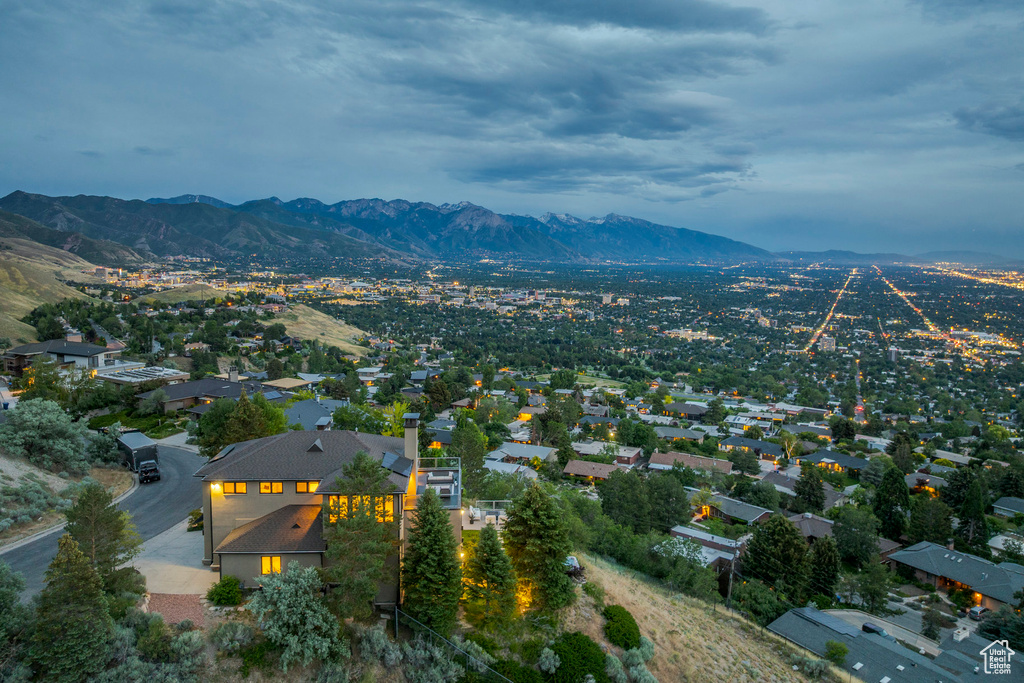 Aerial view of property and surrounding area featuring a mountain backdrop
