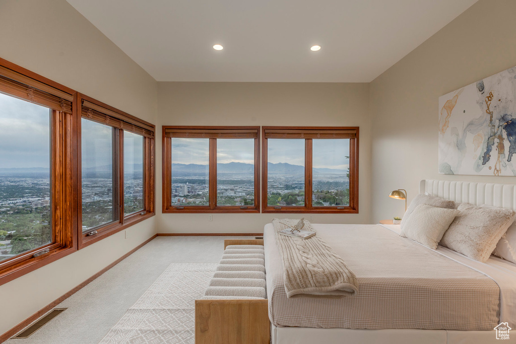 Bedroom with carpet floors, recessed lighting, and a mountain view