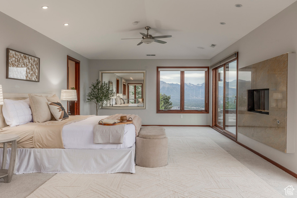 Bedroom featuring carpet floors, recessed lighting, a mountain view, a ceiling fan, and access to exterior