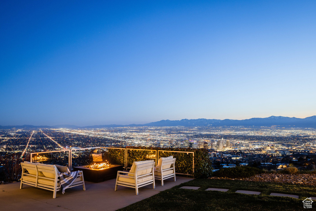 View of patio featuring a fire pit and a mountain view