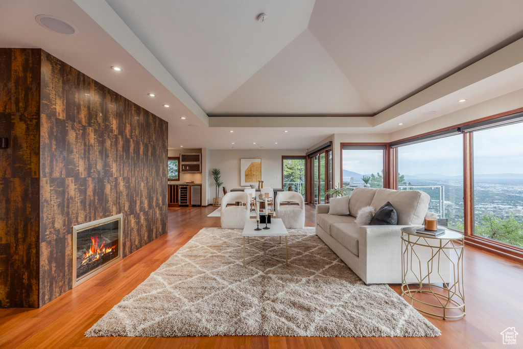 Living area featuring healthy amount of natural light, wood finished floors, a large fireplace, and recessed lighting