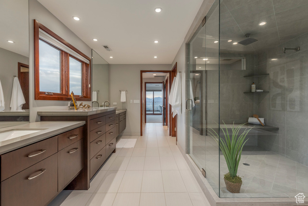 Bathroom with vanity, a stall shower, recessed lighting, and tile patterned flooring