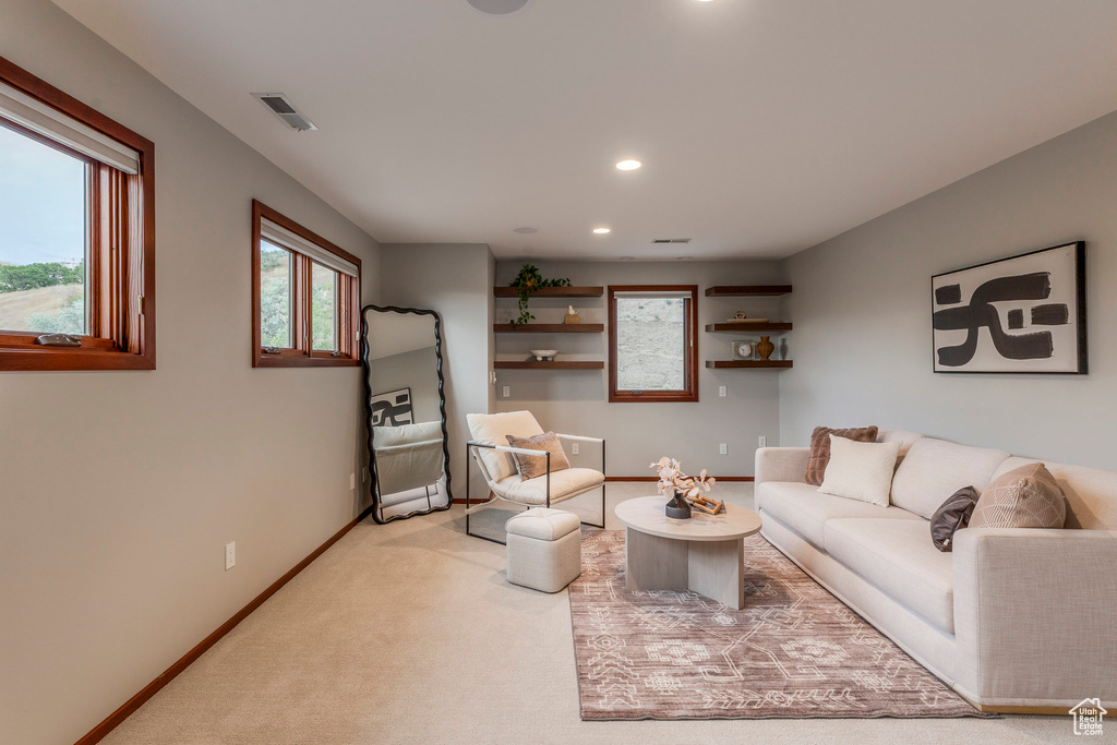 Living area featuring recessed lighting and light carpet