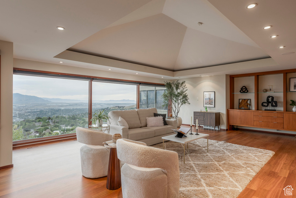 Living room featuring recessed lighting, wood finished floors, a mountain view, and lofted ceiling