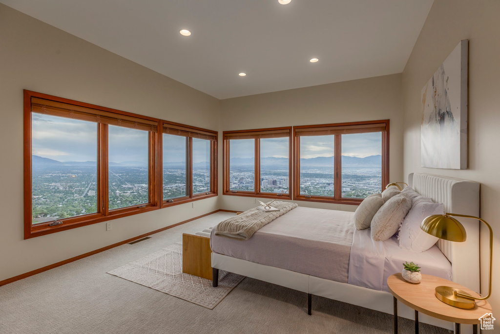 Bedroom featuring carpet, multiple windows, recessed lighting, and a mountain view