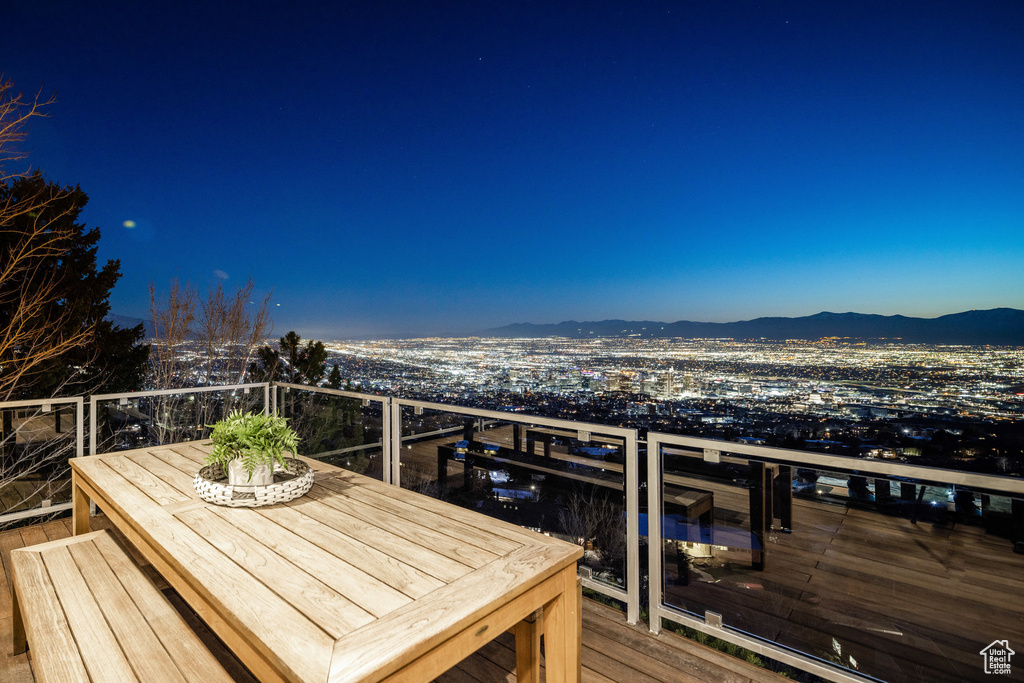 Wooden deck featuring a mountain view and outdoor dining area