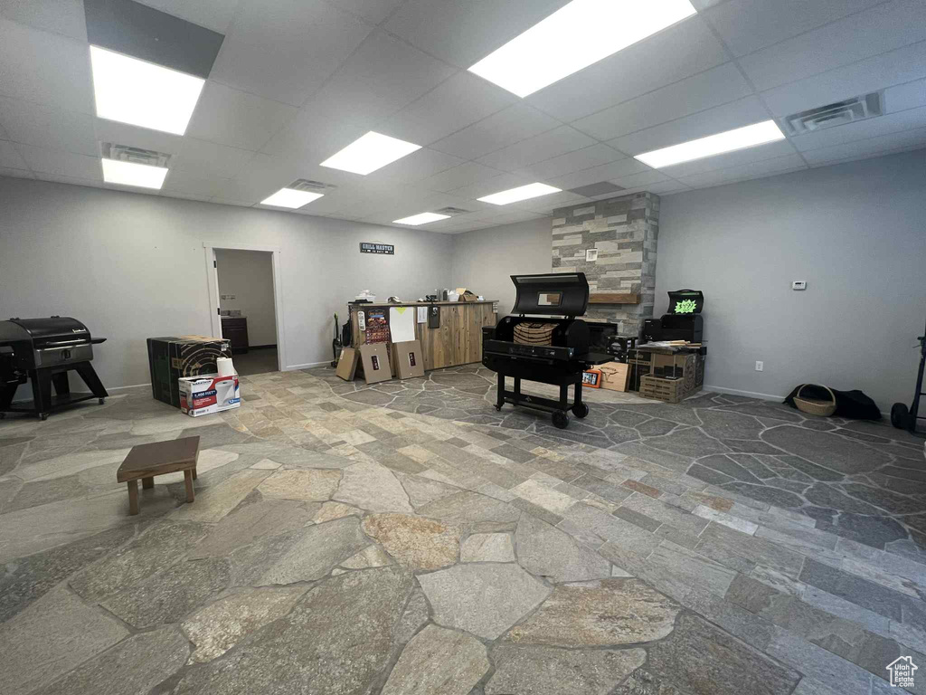 Miscellaneous room with stone floors and a drop ceiling