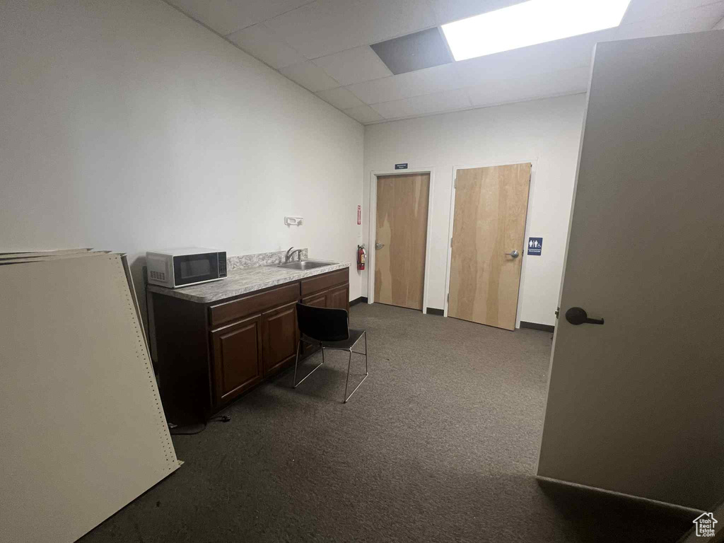 Office area with carpet flooring and a drop ceiling