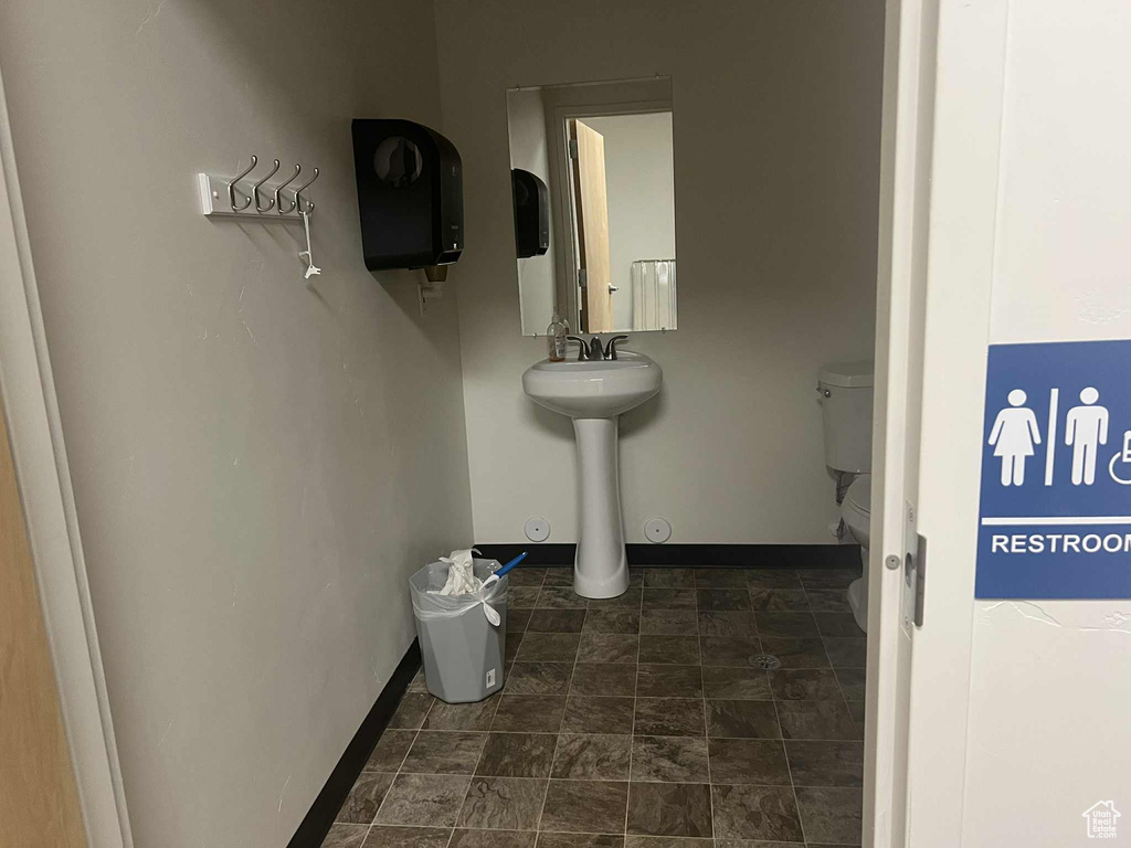 Bathroom with toilet and baseboards
