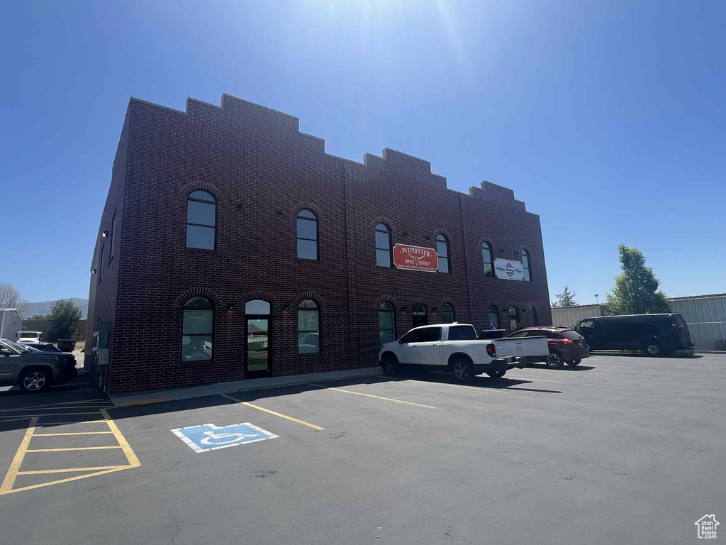 View of property featuring uncovered parking