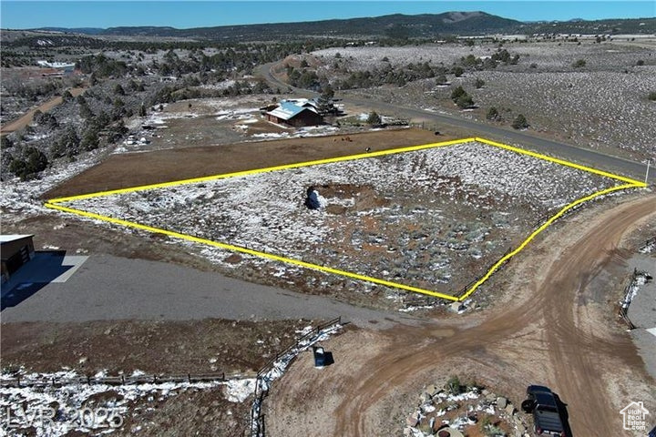 Aerial view of sparsely populated area featuring mountains and property boundaries highlighted