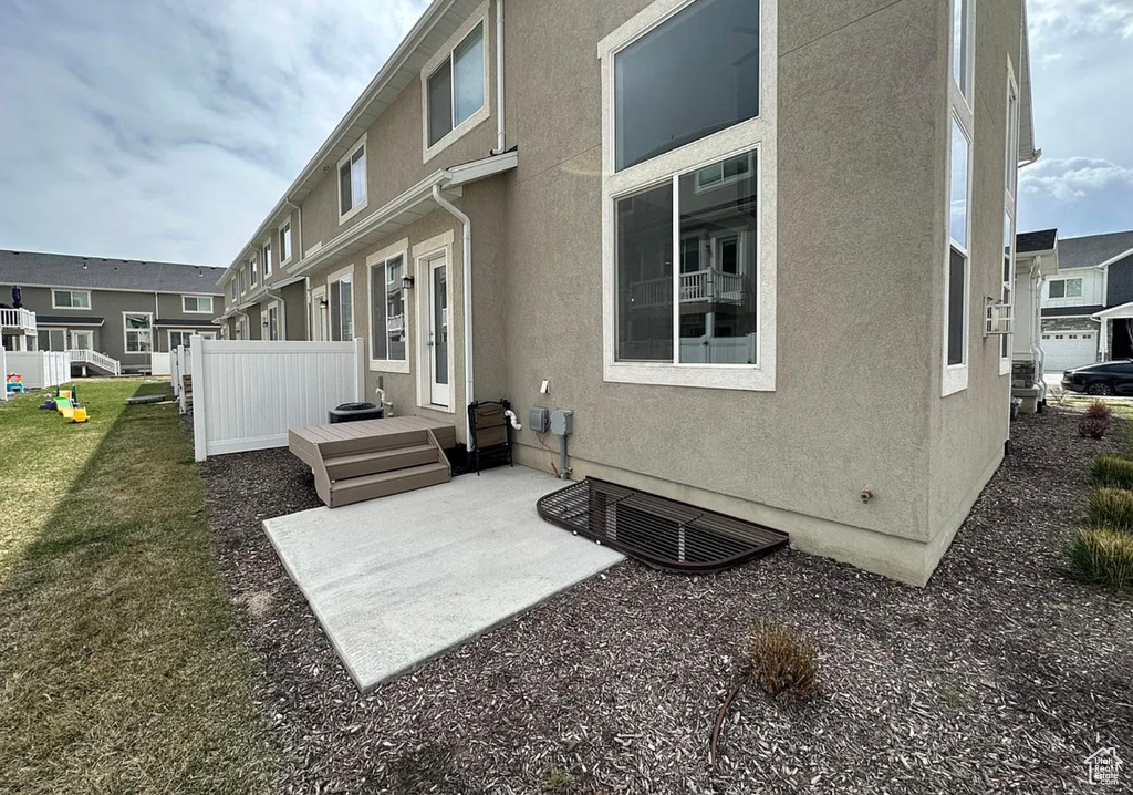 Rear view of property with stucco siding and a patio