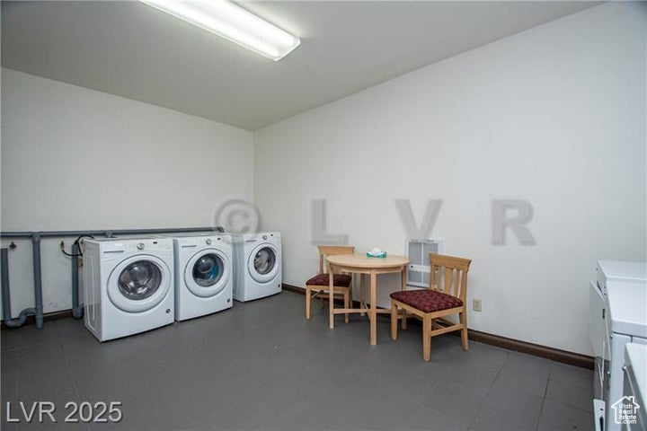 Laundry area with washer and clothes dryer and baseboards