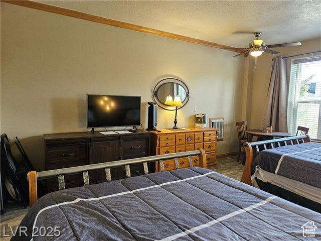 Bedroom featuring a textured ceiling and wood finished floors