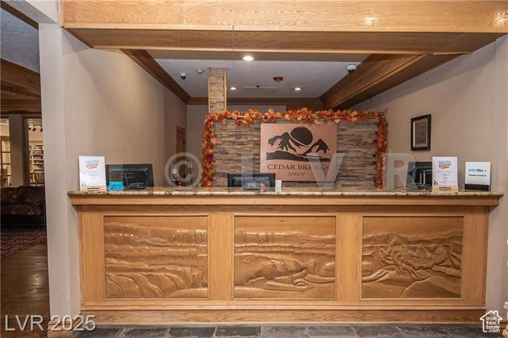 Reception featuring ornamental molding and a bar