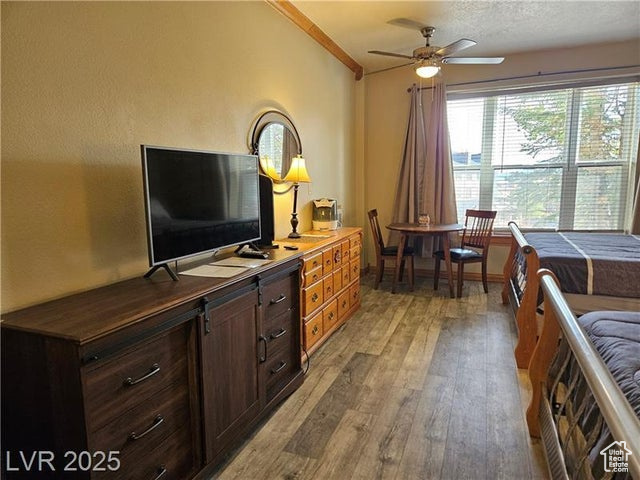 Bedroom featuring light wood-style floors and ornamental molding