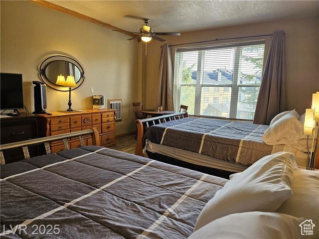 Bedroom featuring a textured ceiling and wood finished floors