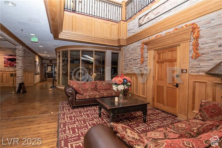 Building lobby featuring a wainscoted wall, crown molding, and recessed lighting