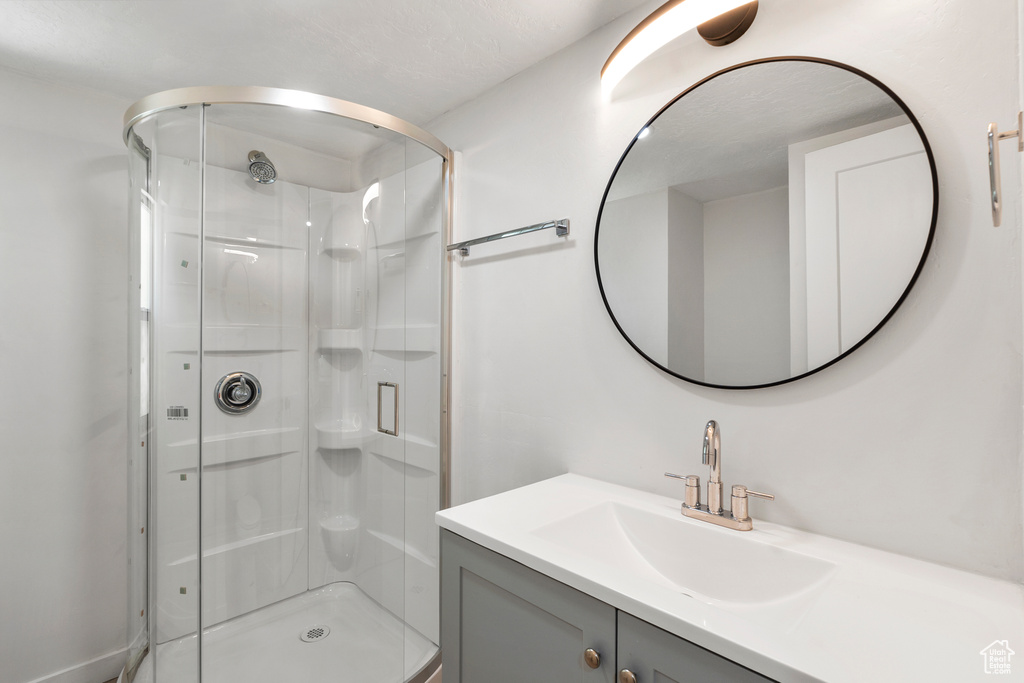 Full bath with a stall shower and vanity