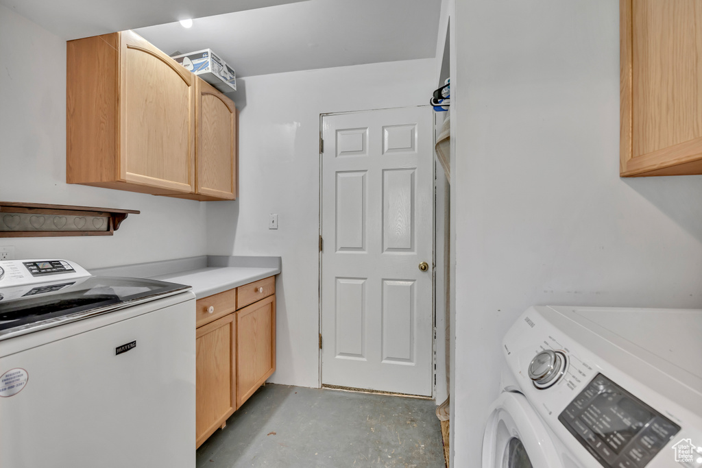 Laundry room with washing machine and clothes dryer and cabinet space