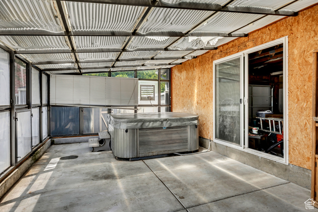 Unfurnished sunroom featuring a jacuzzi