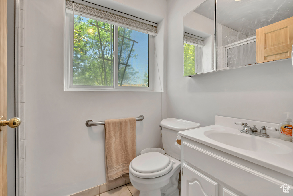 Full bath with plenty of natural light, vanity, an enclosed shower, and tile patterned flooring