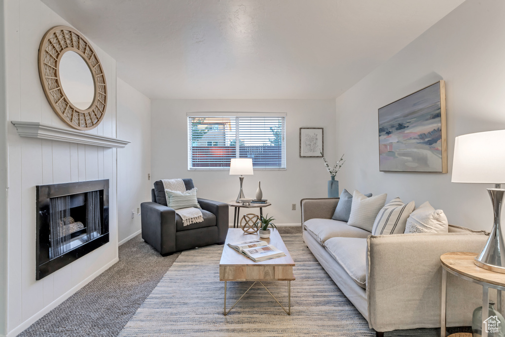 Living area featuring a fireplace and carpet floors