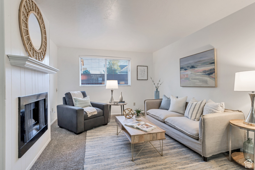 Living area featuring a fireplace and carpet flooring
