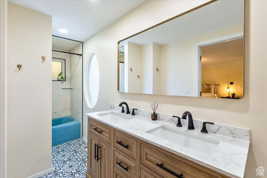 Full bathroom featuring double vanity, bathing tub / shower combination, and tile patterned floors