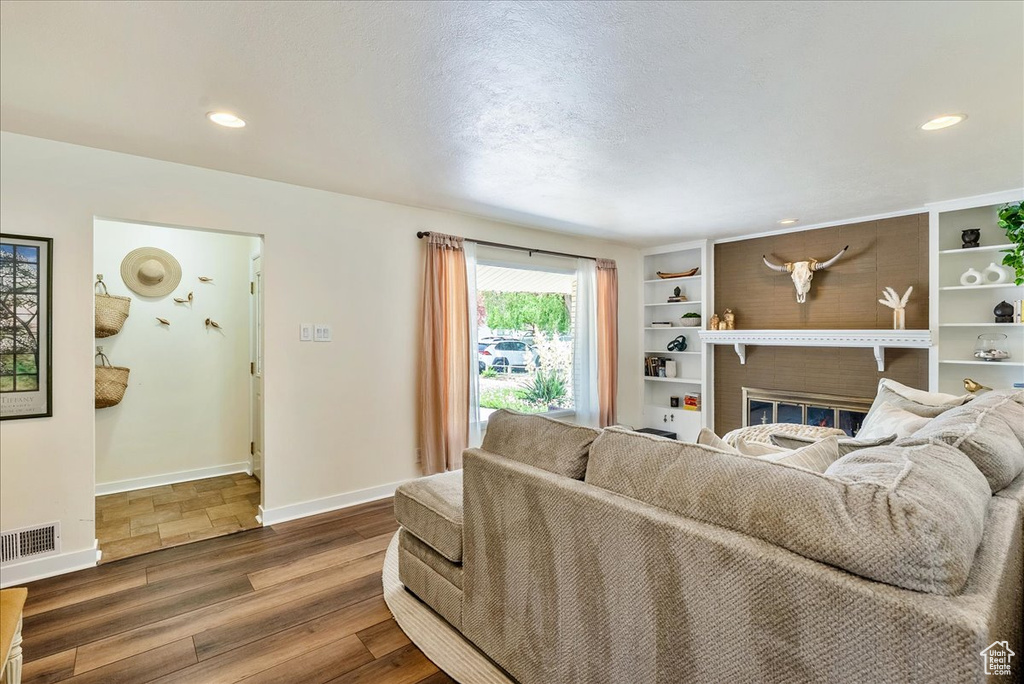 Living room with wood finished floors and recessed lighting