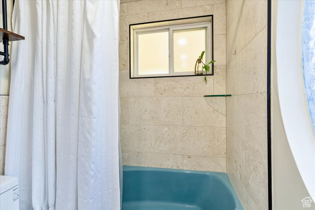 Bathroom featuring toilet and shower / bath combo