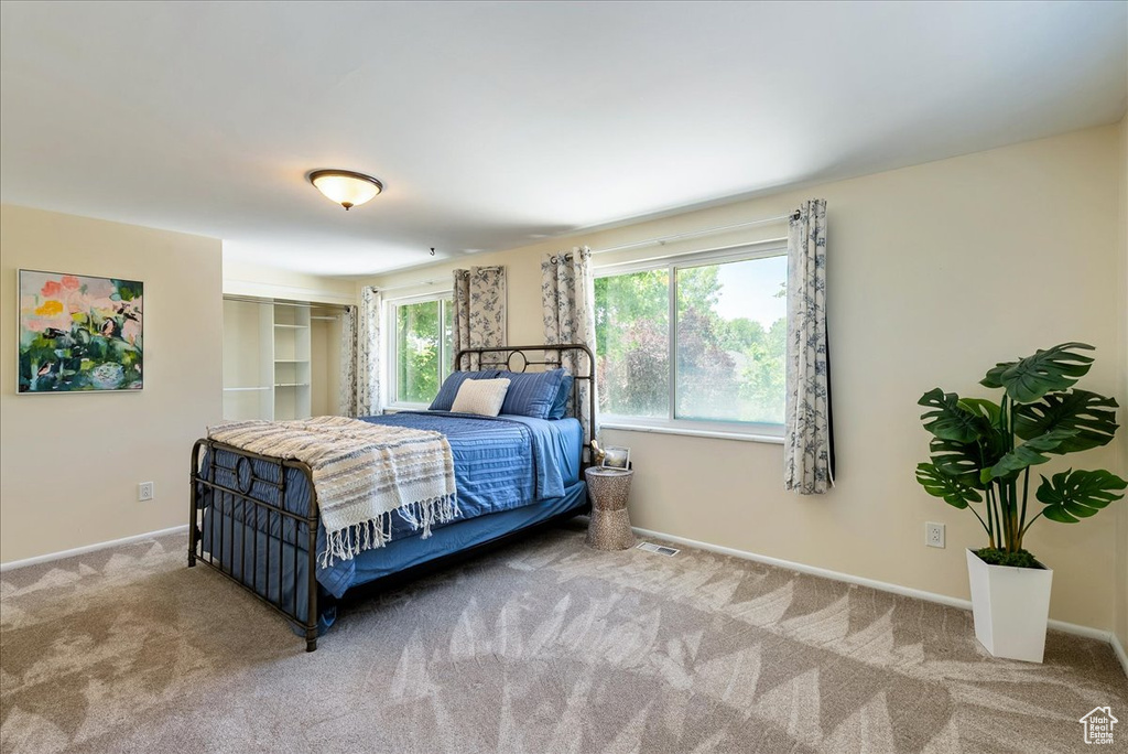 Carpeted bedroom featuring baseboards