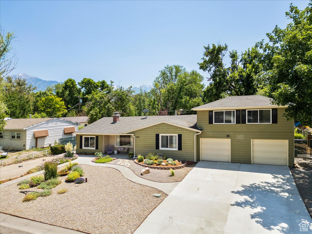 View of front of house with concrete driveway and a garage