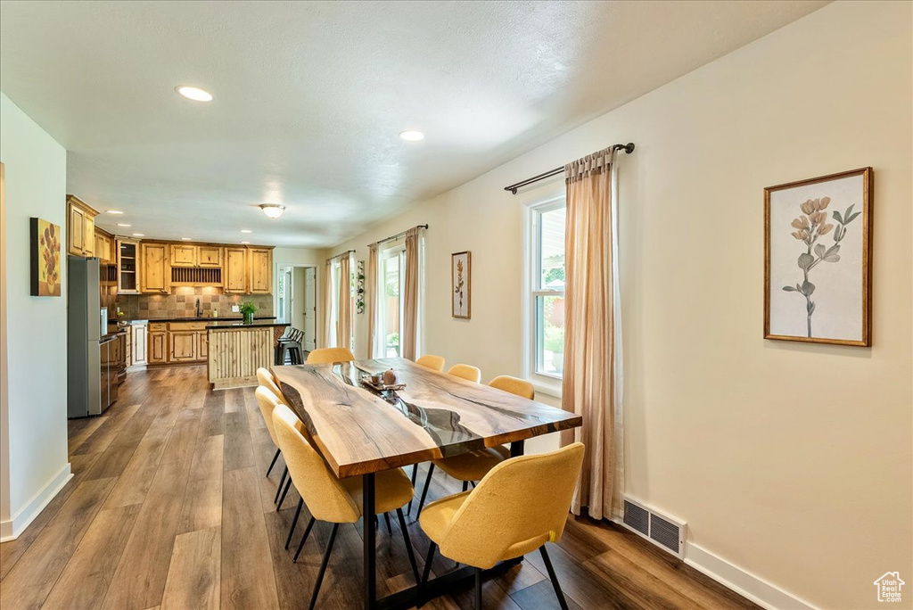 Dining space with recessed lighting and dark wood finished floors
