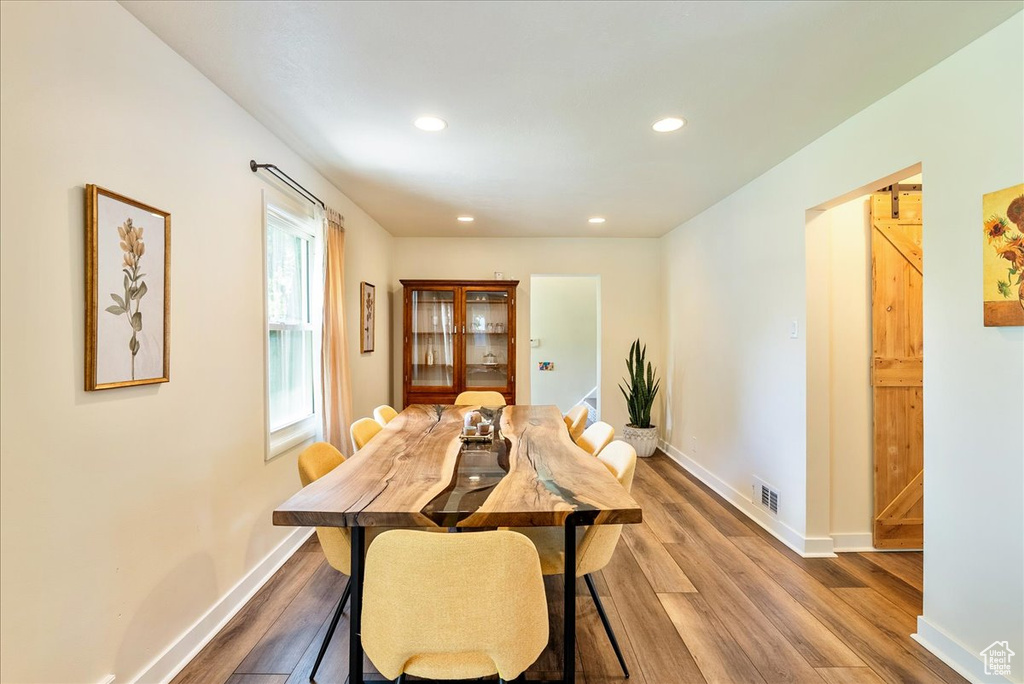 Dining space featuring wood finished floors and recessed lighting