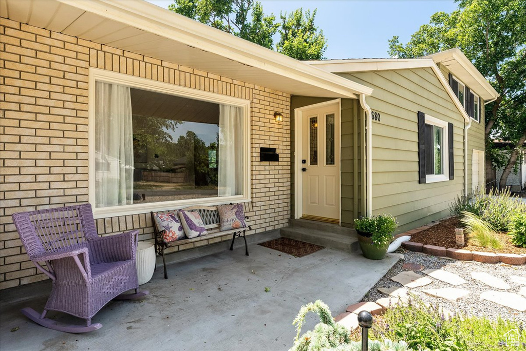 Doorway to property with brick siding