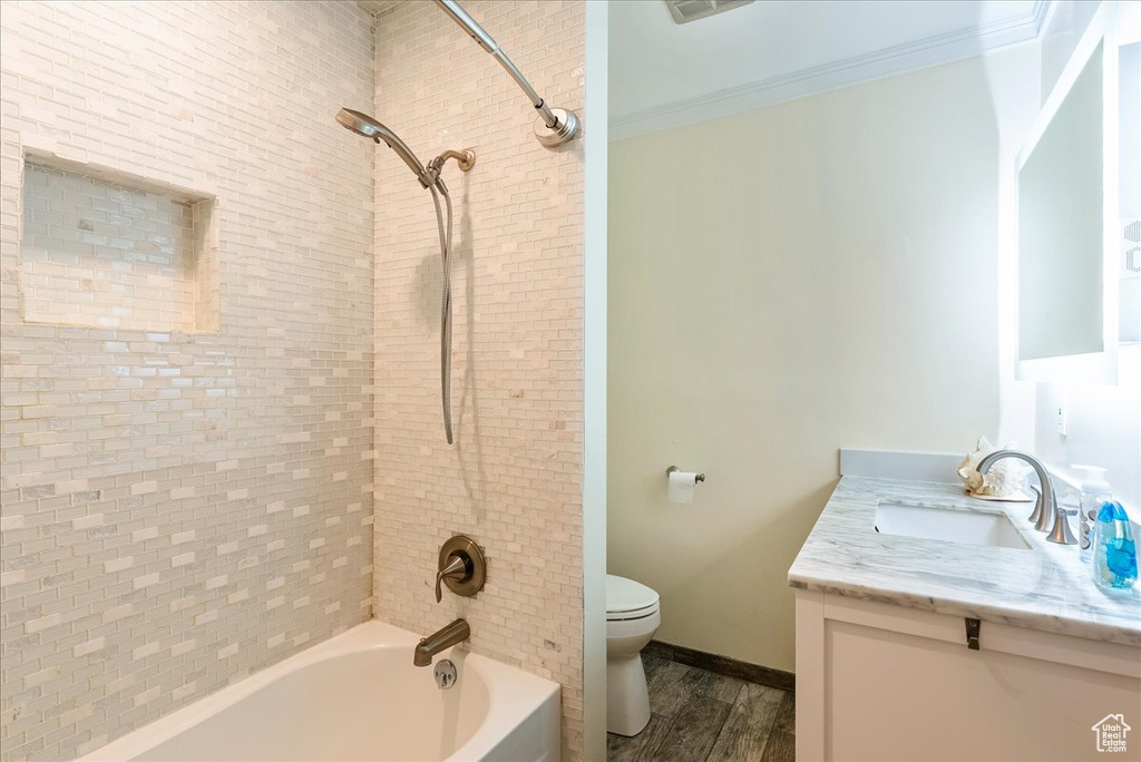 Full bathroom with vanity, tub / shower combination, and wood finished floors