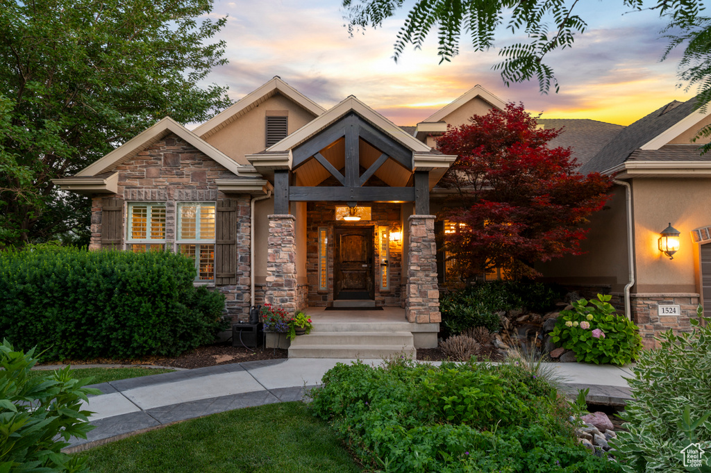 Craftsman-style home with stone siding and stucco siding